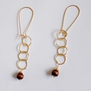 Gold 4 Ring Dangle Drop Earrings with wood.